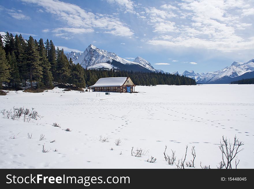 A frozen lake and cabin covered in snow. A frozen lake and cabin covered in snow.
