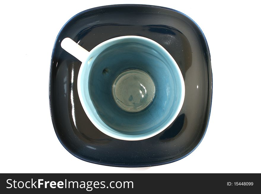 Tea cup with a spoon on the saucer, on a white background