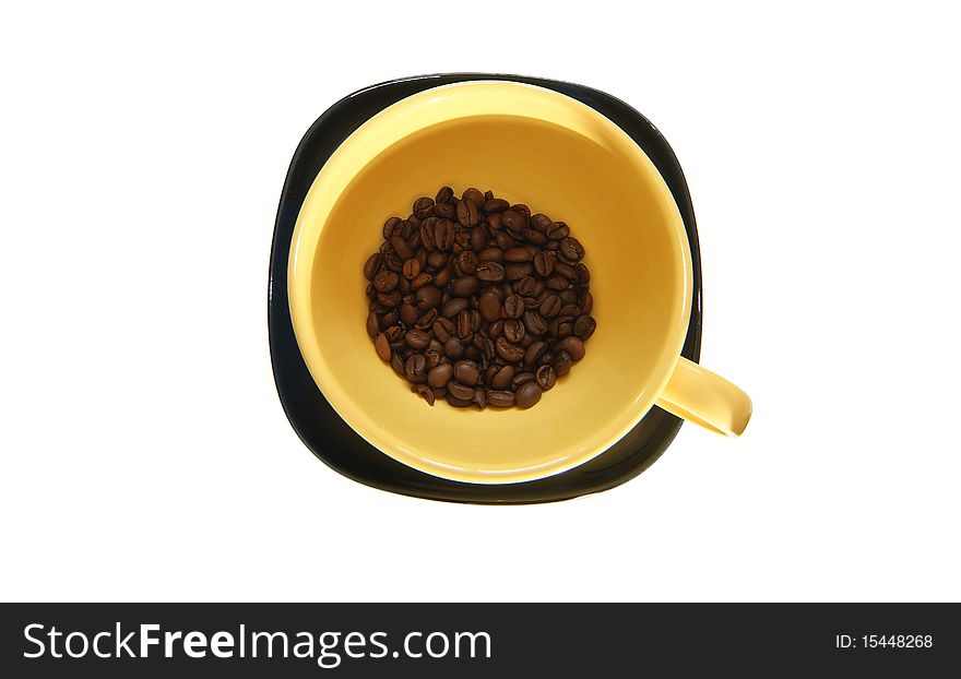 Large yellow cup and black saucer, top view, isolated on white