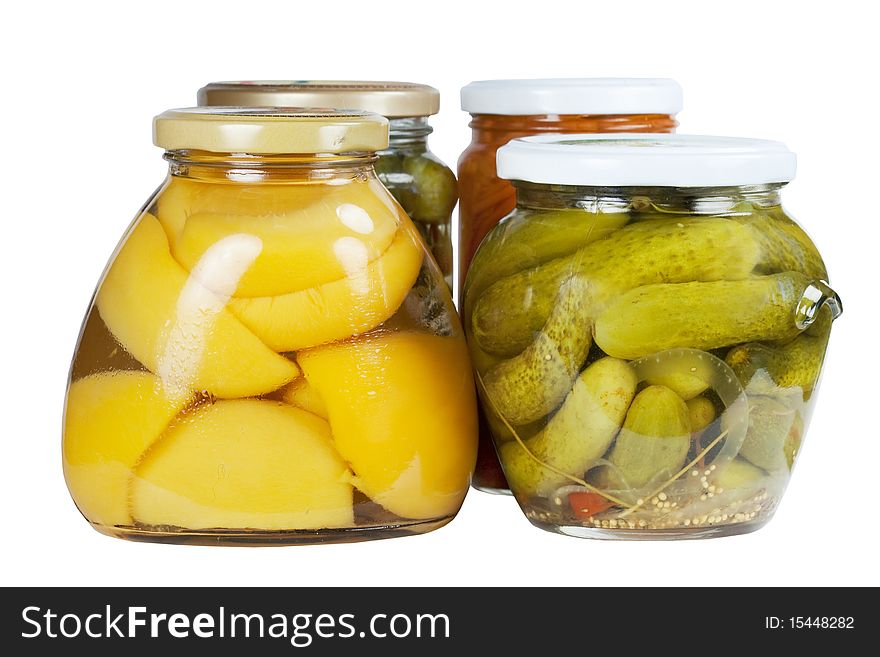 Banks canned apricots, cucumbers and carrots on a white background