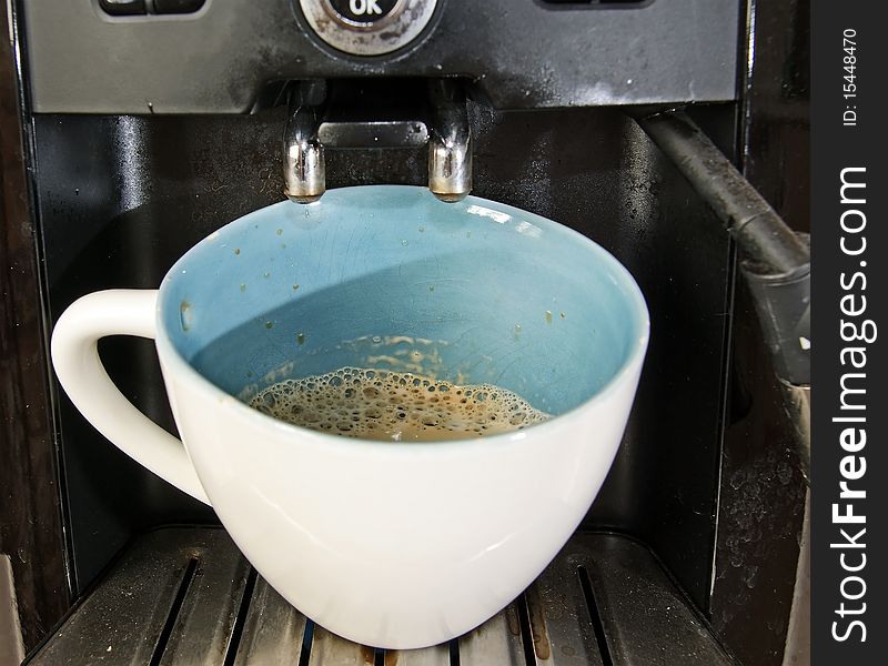 Espresso machine with cup of black coffee