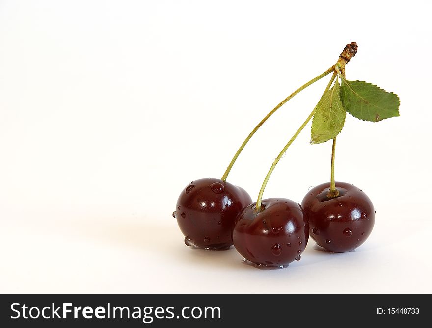 Fresh bright red cherry closeup, isolated on a white background. Fresh bright red cherry closeup, isolated on a white background