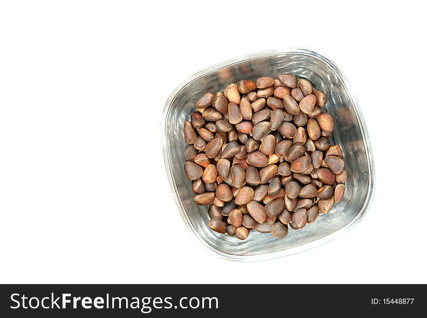 Not peeled pine nuts closeup, isolated