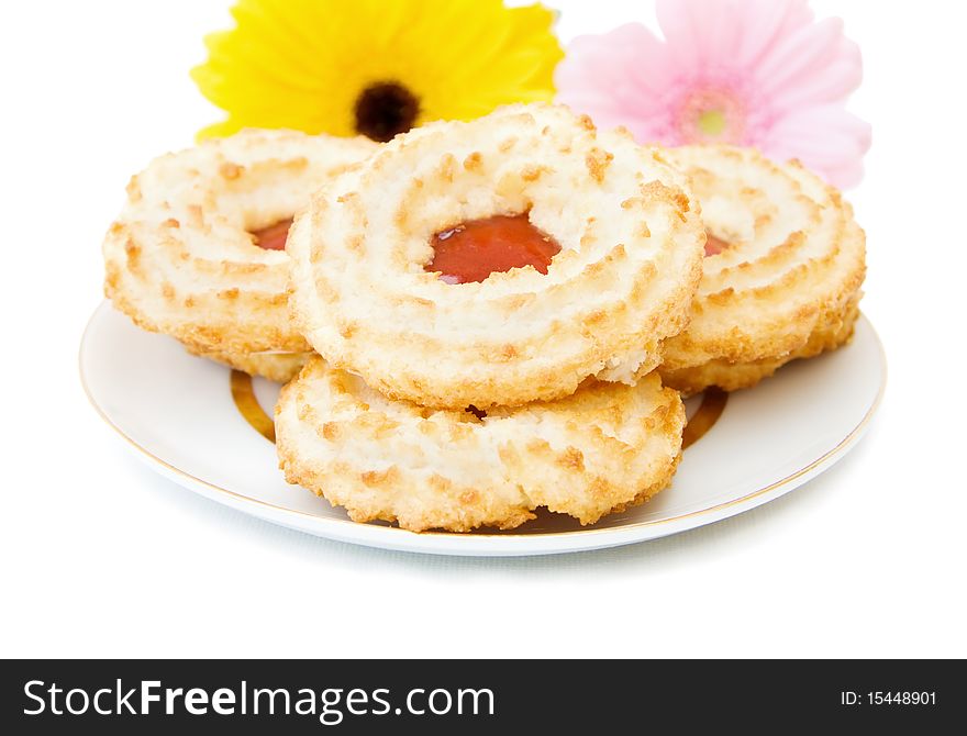 Jam and coconut cookies on a plate. Isolated over white background.