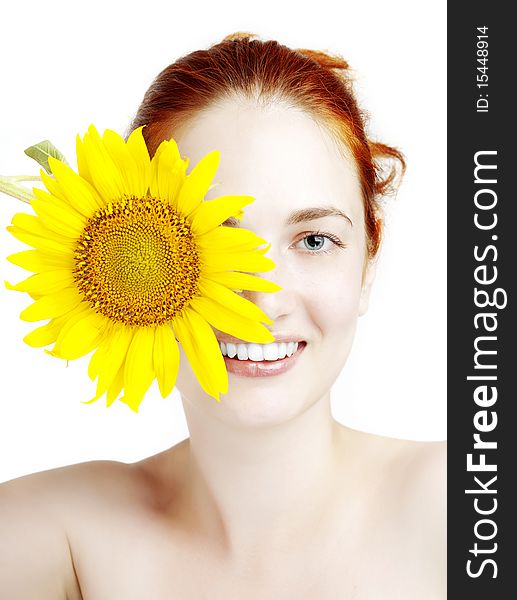 Smiling girl with a sunflower in the hands