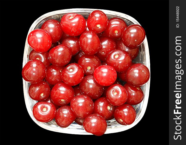 Fresh ripe bright red cherry closeup, isolated on black background. Fresh ripe bright red cherry closeup, isolated on black background