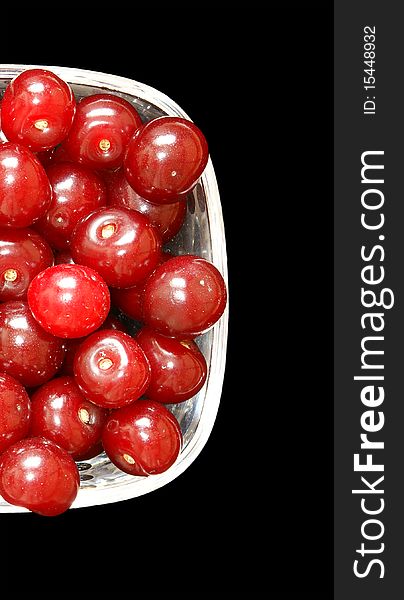 Fresh ripe bright red cherry closeup, isolated on black background. Fresh ripe bright red cherry closeup, isolated on black background
