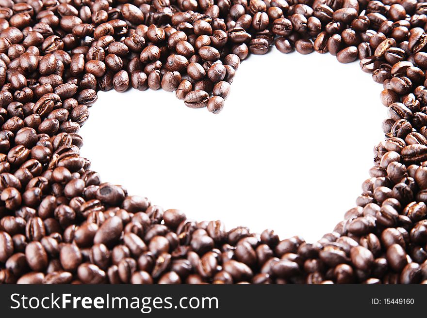 Coffee beans with the outline of a heart, closeup on white background. Coffee beans with the outline of a heart, closeup on white background