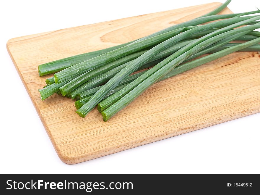Green onion on wooden plate