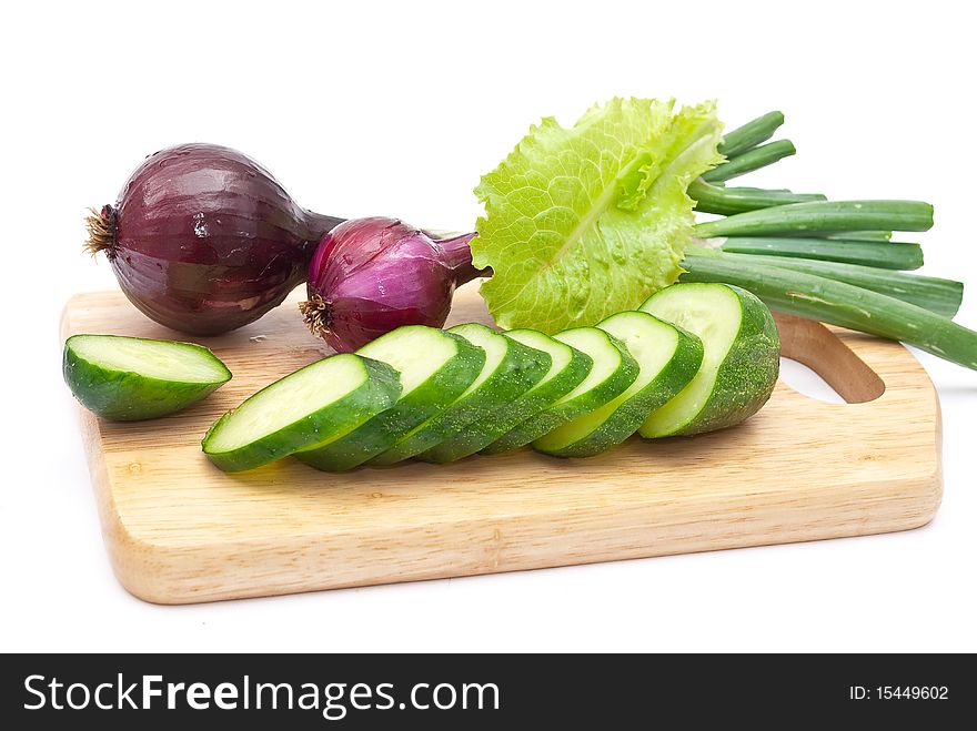 Green cucumber slices with red onion on white