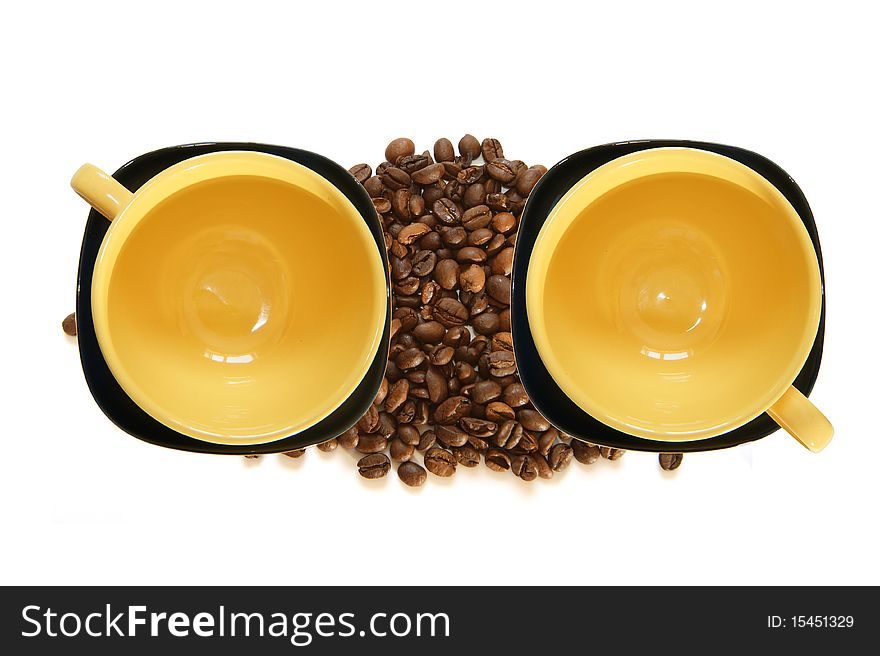 Large yellow cup and black saucer, top view, isolated on white