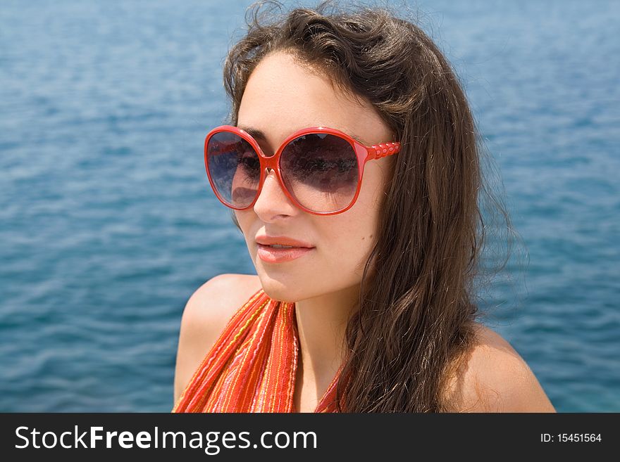 Young girl in red sunglasses