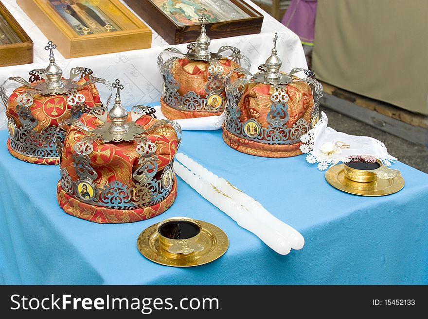 Crowns lay on a table before wedding on a cloth a number of a ring the book of a candle and wine. Crowns lay on a table before wedding on a cloth a number of a ring the book of a candle and wine