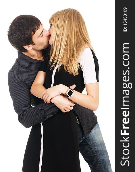 Young elegant couple is kissing against white background