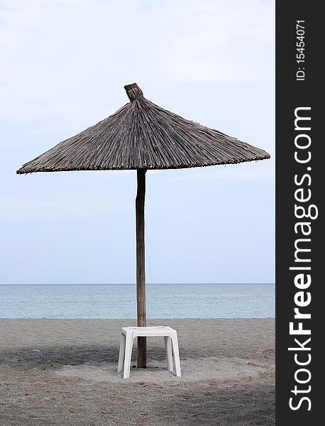 View of two chairs and umbrella on the beach. View of two chairs and umbrella on the beach