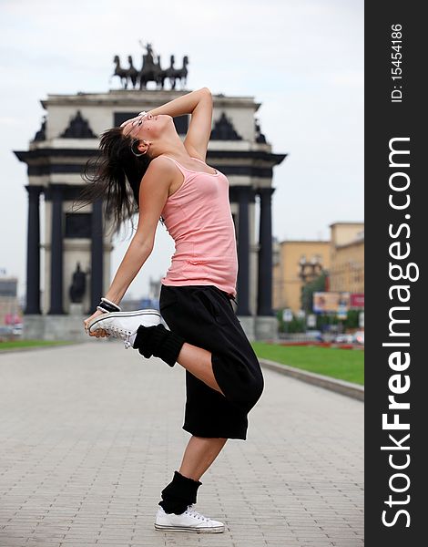 Woman modern ballet dancer in sity against classic arch