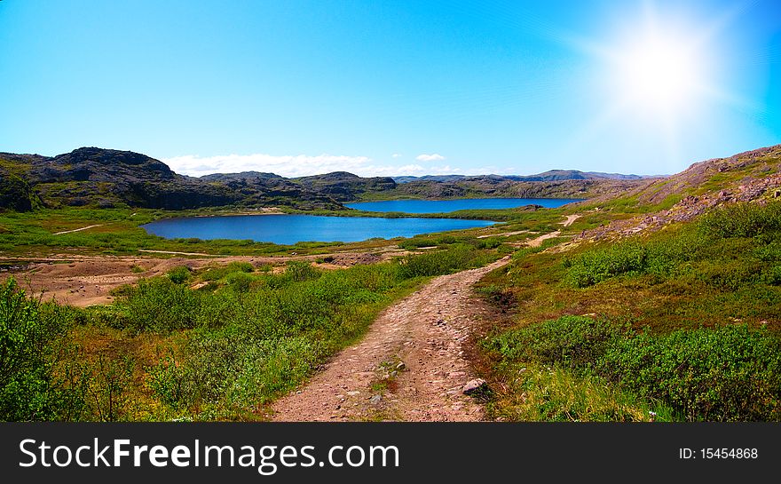 Two lakes surrounded by green hill. Coast of Kola Peninsula. Teriberka.