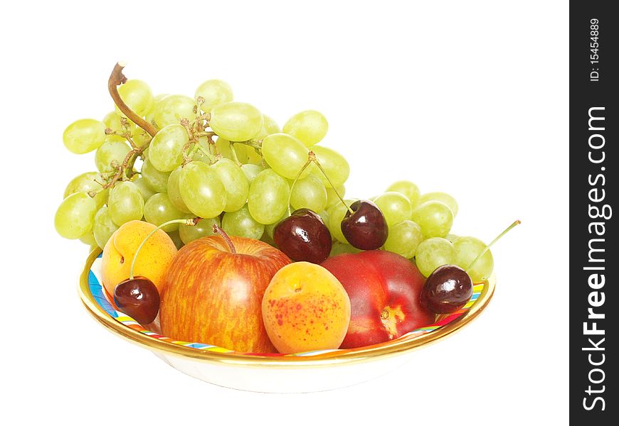 Various fruit in a bowl on a white background