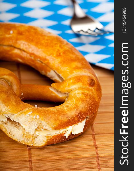 Bavarian pretzel with butter isolated on white