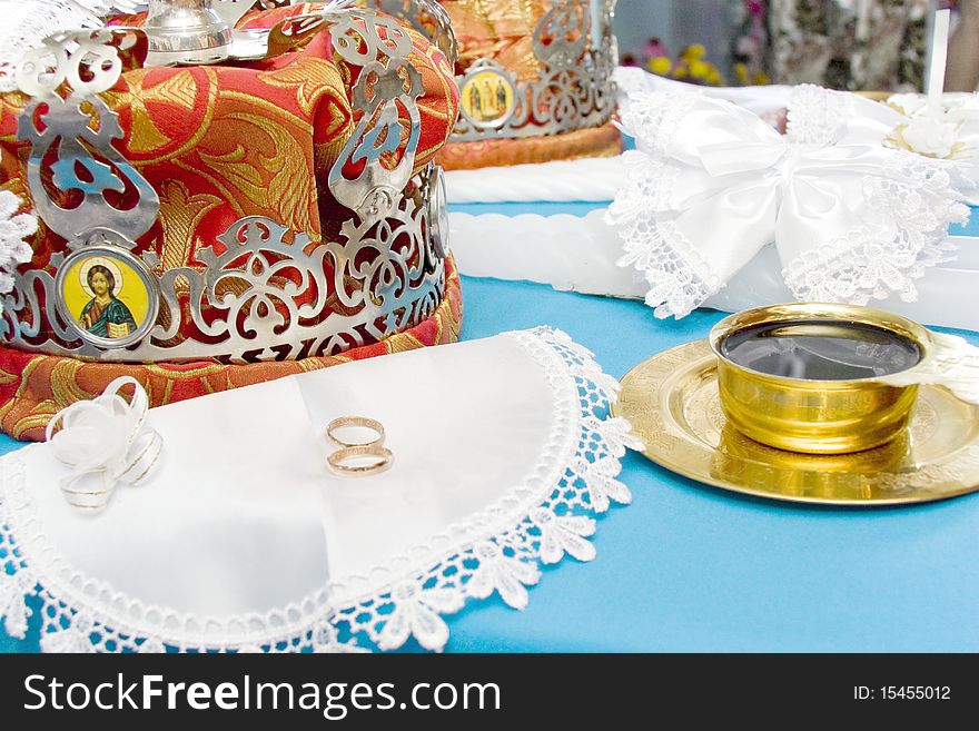 Crowns lay on a table before wedding on a cloth a number of a ring the book of a candle and wine. Crowns lay on a table before wedding on a cloth a number of a ring the book of a candle and wine