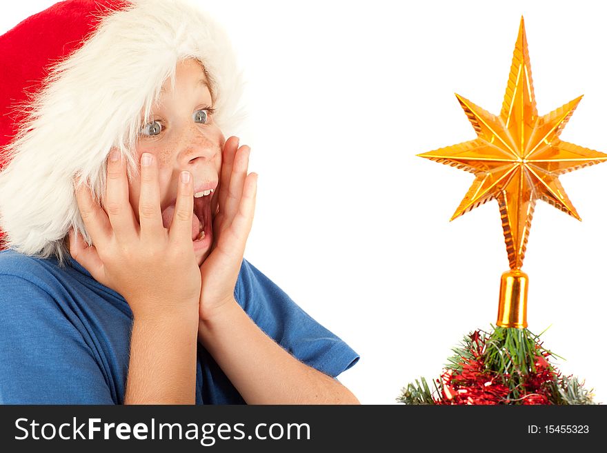 Young boy is excited while looking at Christmas tree with copyspace. Young boy is excited while looking at Christmas tree with copyspace