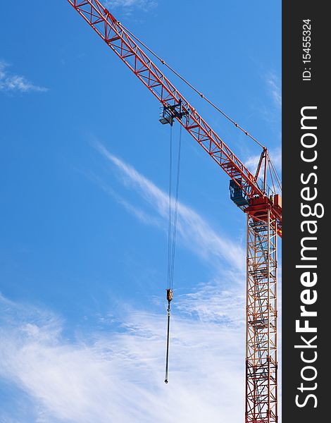 The crane elevating against the blue sky