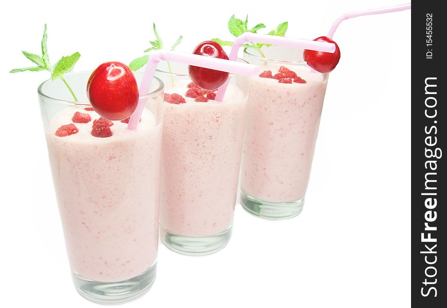 Three glasses of fruit cocktails with cherry and raspberry