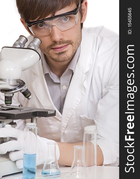 Male researcher with microscope on white background