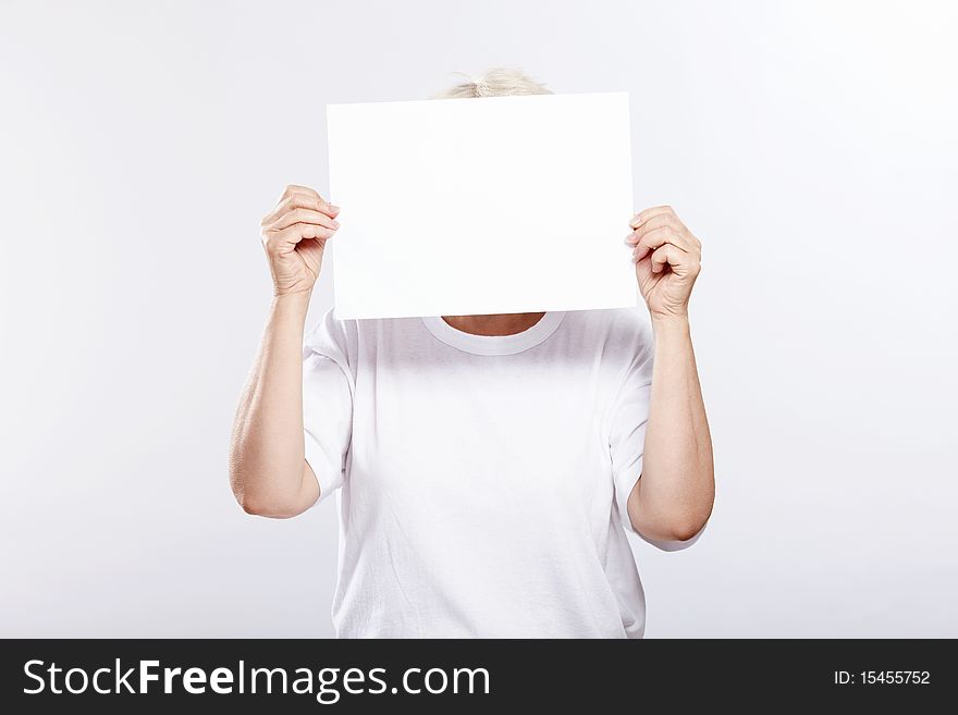 An elderly woman with an empty plate from a person on a white background. An elderly woman with an empty plate from a person on a white background