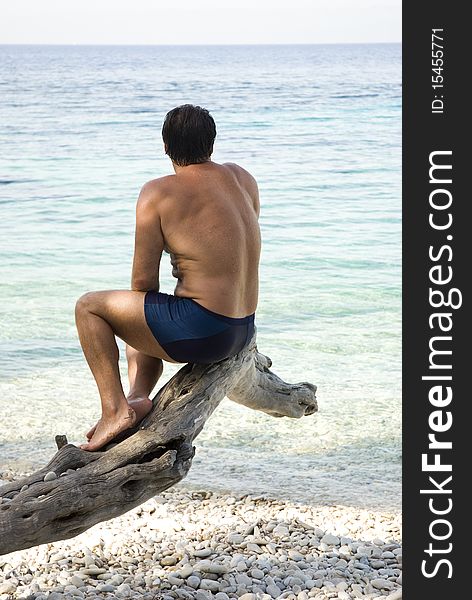 Man Sitting On Beach