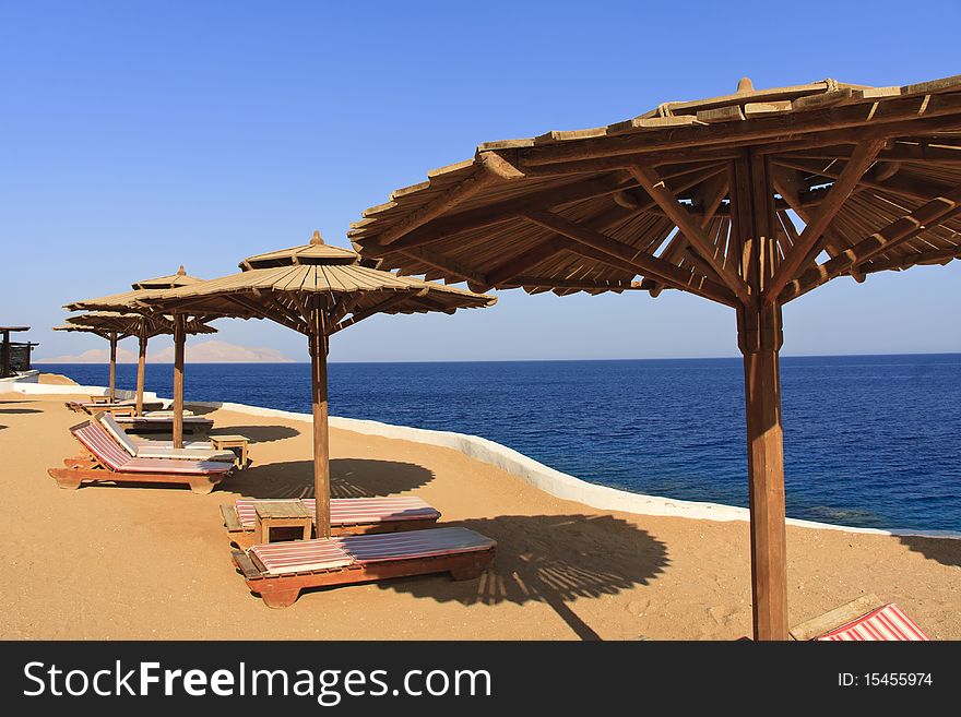 Empty sunbathe and beach umbrella in Sharm El Sheik. Empty sunbathe and beach umbrella in Sharm El Sheik