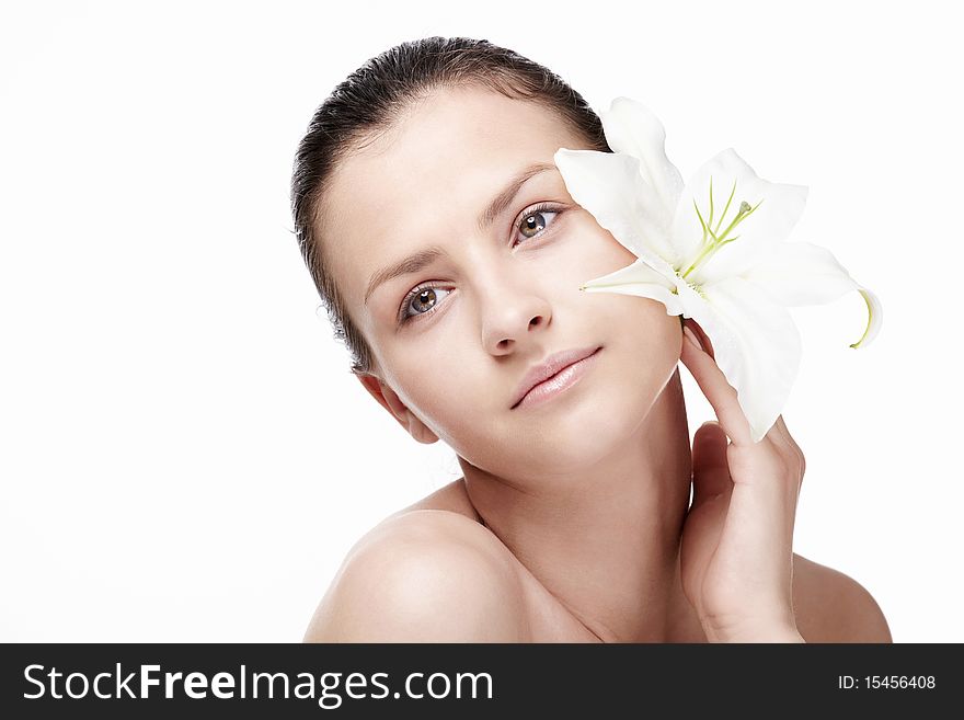 Young attractive girl with a lily on a white background. Young attractive girl with a lily on a white background