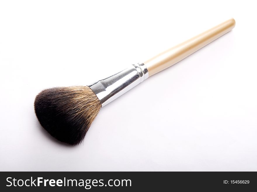 A brush for makeup on white background