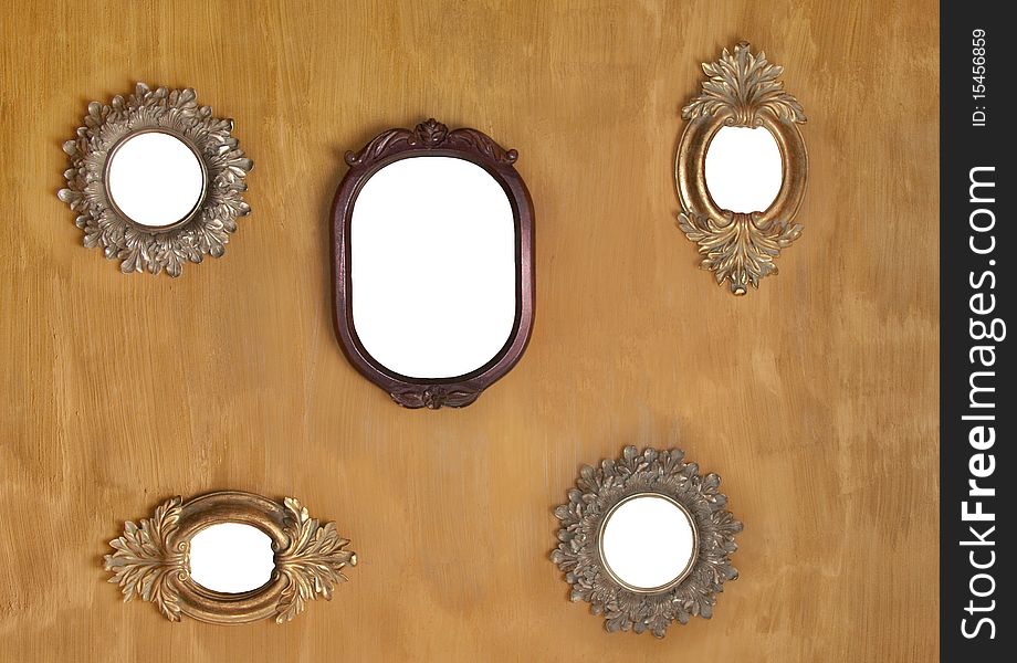 Five empty mirror frames against yellow texture wall. Five empty mirror frames against yellow texture wall