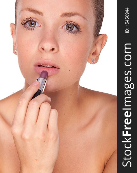 Close up of a female applying a lipstick, white background. Close up of a female applying a lipstick, white background.