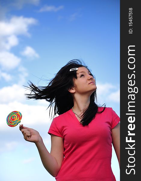 Girl with lollipop and blue sky