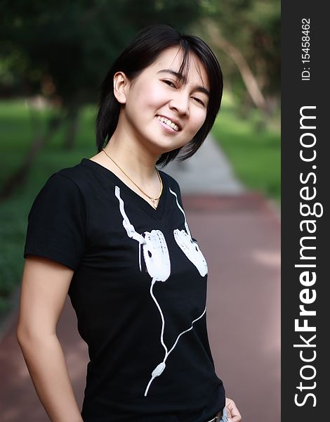 Asian woman smiling in the park