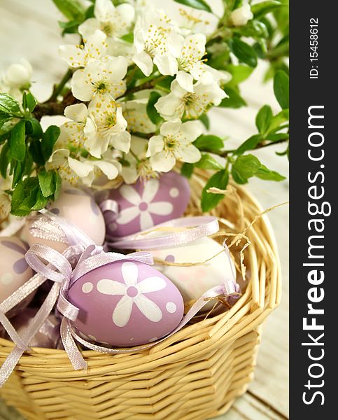 Easter eggs and branch with white flowers