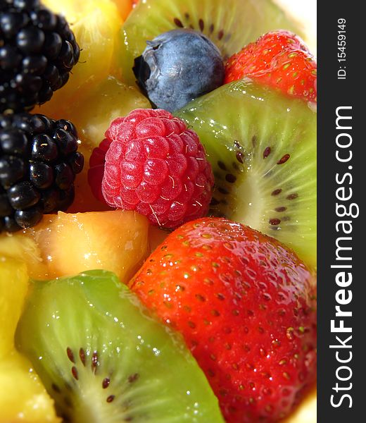 Multicolored fresh summer fruit-dessert closeup. Multicolored fresh summer fruit-dessert closeup