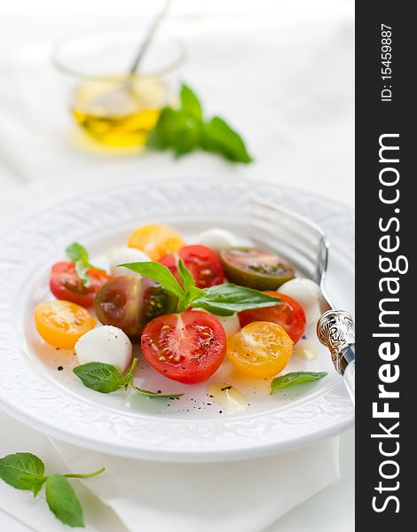 Caprese salad with mozzarella, tomatoes and fresh basil