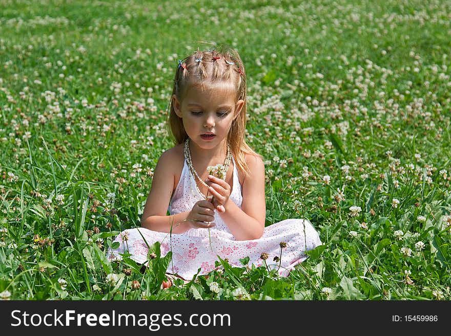 A Little Girl Sitting In The Meadow