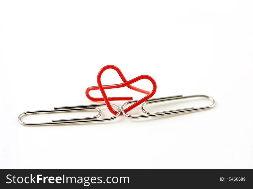 Heart shape paper clip on white background