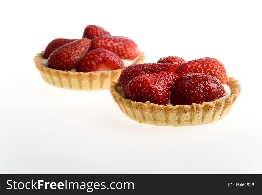 Studio shot of strawberry tarts isolated on a white background.