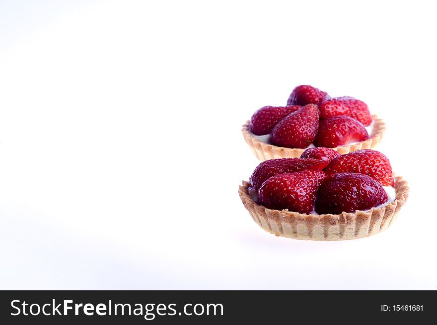 Studio shot of strawberry tarts isolated on a white background.