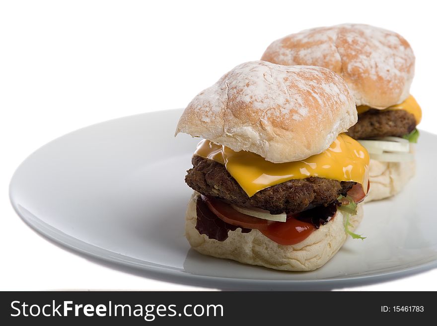 Home made burgers on a plate isolated on a white background