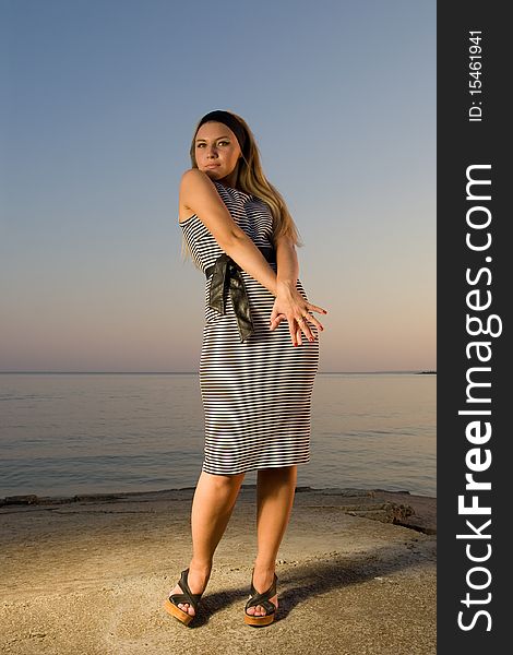 Beautiful young woman posing at sea