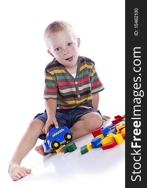 The kid plays with cubes on a white background