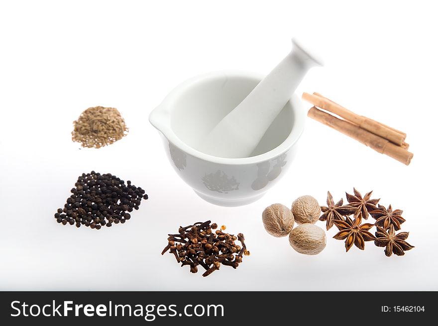 Mortar and pestle with mixed spices on a white background. Mortar and pestle with mixed spices on a white background