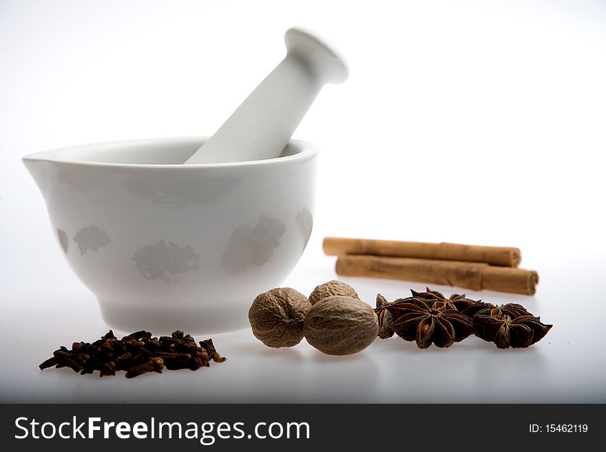 Mortar and pestle with mixed spices on a white background. Mortar and pestle with mixed spices on a white background