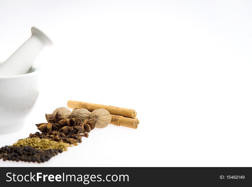 Mortar and pestle with mixed spices on a white background. Mortar and pestle with mixed spices on a white background